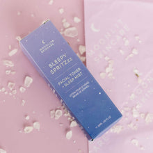 Moonlit Skincare Sleepy Spritzzz facial toner and sleepy pillow mist packaging on pink background surrounded by white salt