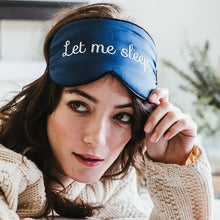 Close-up of girl with brown hair in white sweater wearing 'Let Me Sleep' Sleeping Eye Mask.