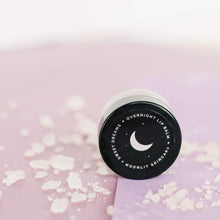 Sweet Dreams Moonlit Skincare overnight lip balm with white salt surrounding it on pink paper