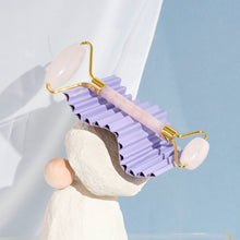 Moonlit Skincare Rose Quartz Facial Roller Tool on top of a structure with a white curtain behind on blue background