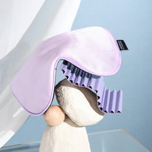 Lilac Purple Silk Sleeping Eyemask on white rock structure with white curtain behind it on blue background