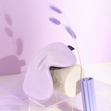 Lilac Purple Silk Sleeping Eyemask on white structure with purple pampas on purple background