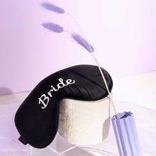 Bride silk eyemask on white structure with purple pampas grass on purple background