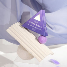 Moonlit Skincare Serene Clean Soap on top of a structure with purple curtain behind it 