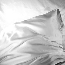 Pillow fitted with 'Cloud 9' Ivory White Silk Pillowcase on white silk bedsheets