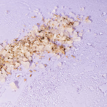 Shot of scattered Slumber Bath Salts containing frankincense essential oils, lavender buds, and geranium to induce relaxing sleep