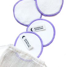 4 Reusable Bamboo Cotton Rounds and washable meshbag laid out on white background