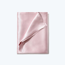 Close-up of folded Blush Pink Cloud 9 Silk Pillowcase on white background